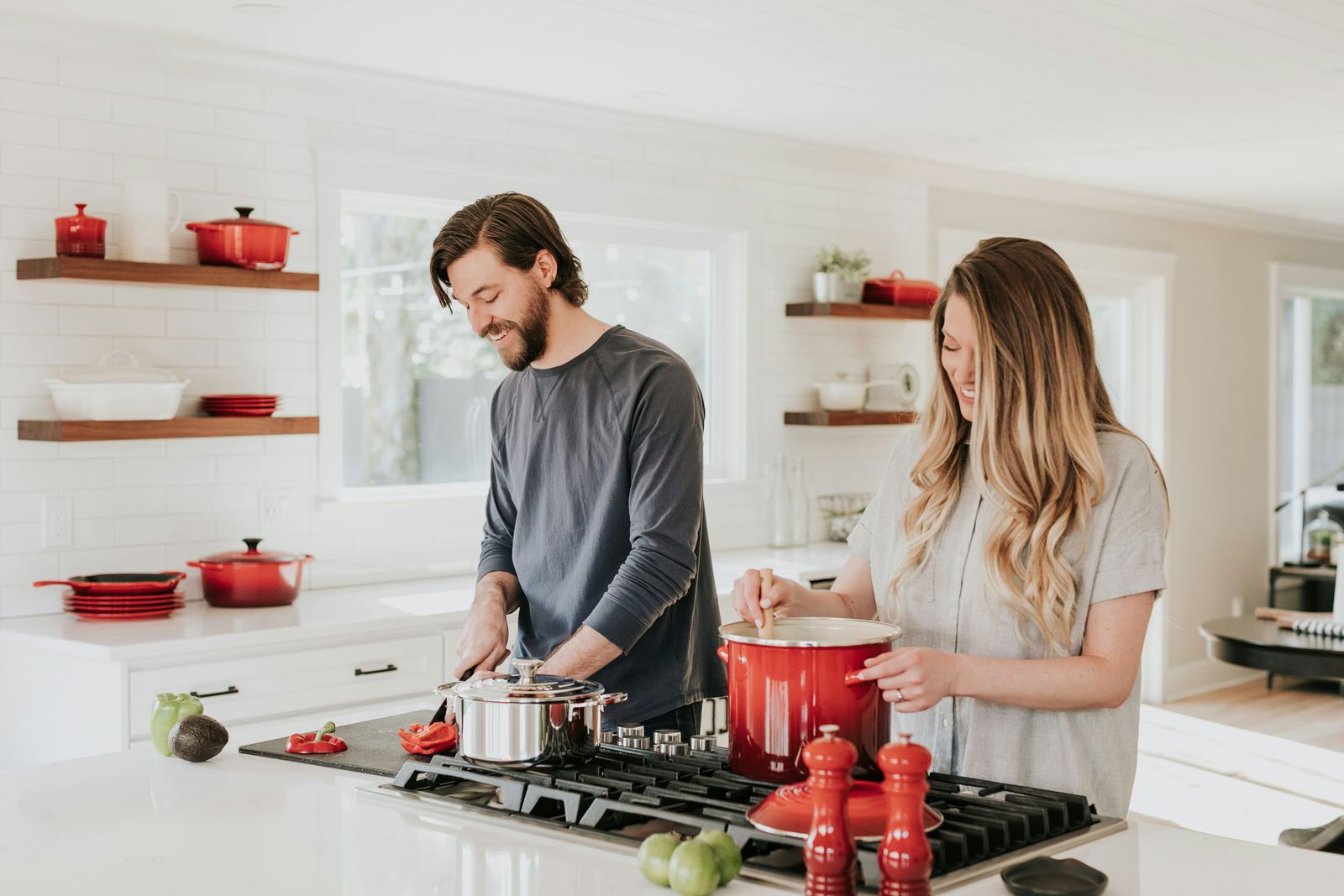 A couple cooking together in a clean kitchen
